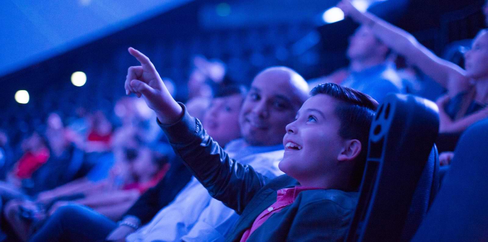 Child pointing at dome screen in Heikoff Giant Dome Theater