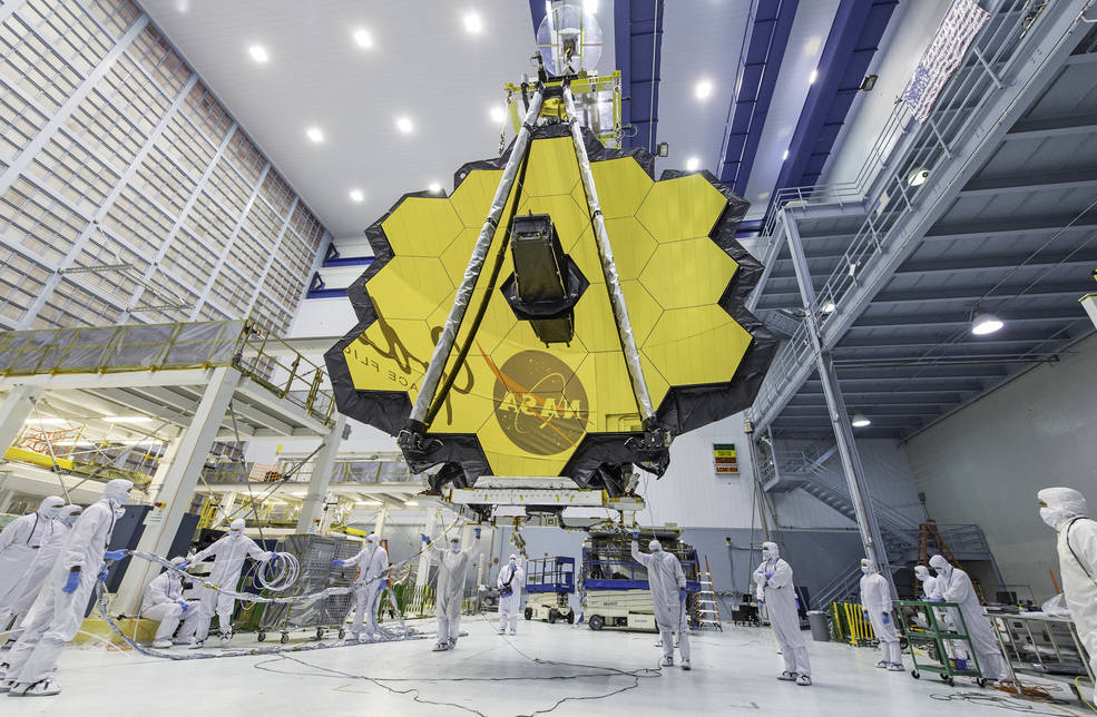 NASA technicians use a crane to lift and move the James Webb Space Telescope, with its 21-foot primary mirror deployed, inside a clean room at NASA’s Goddard Space Flight Center in Greenbelt, Maryland, in April 2017. Credits: NASA/Desiree Stover