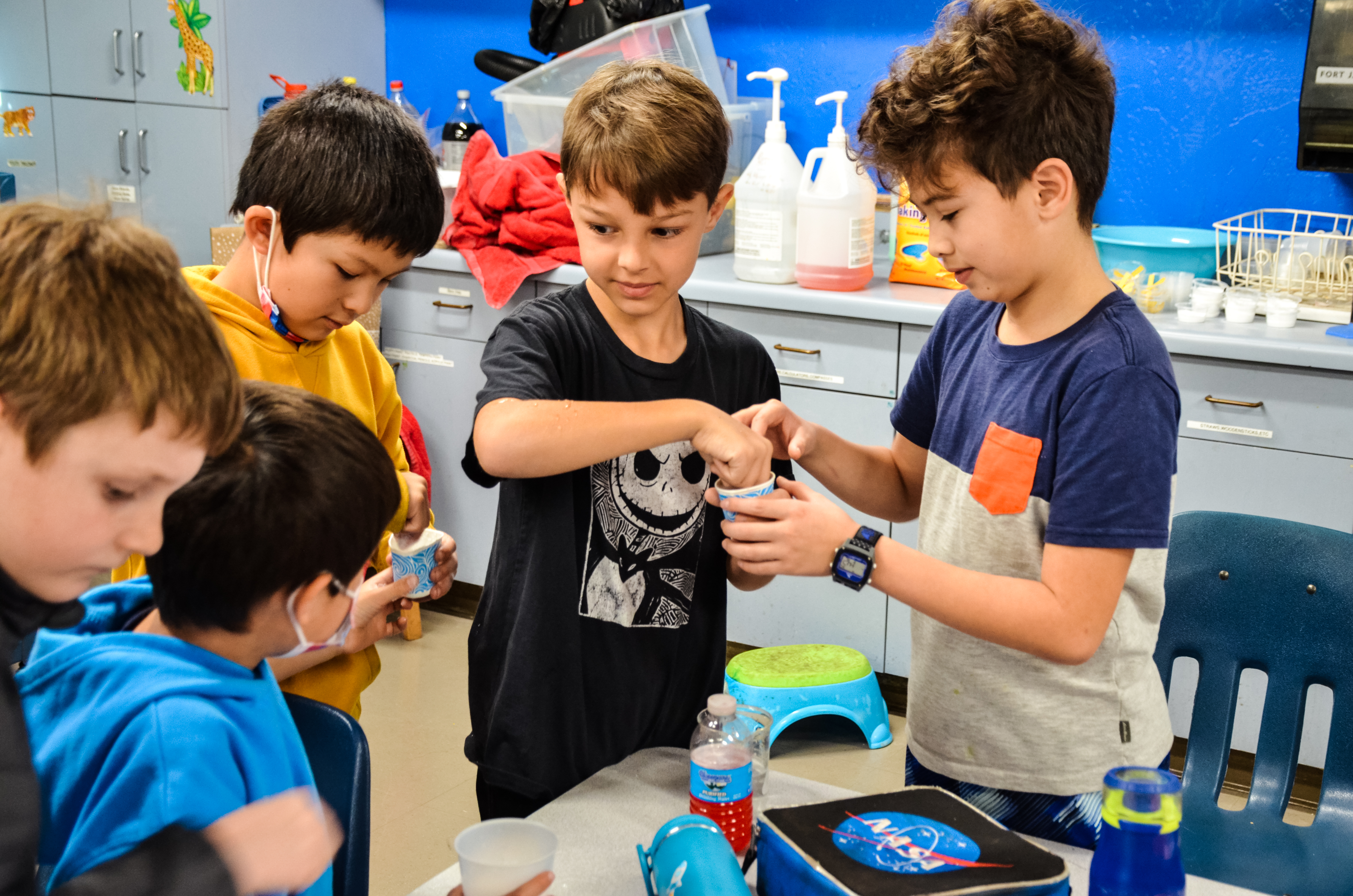 Image of 5 students experimenting with water and sodium  
