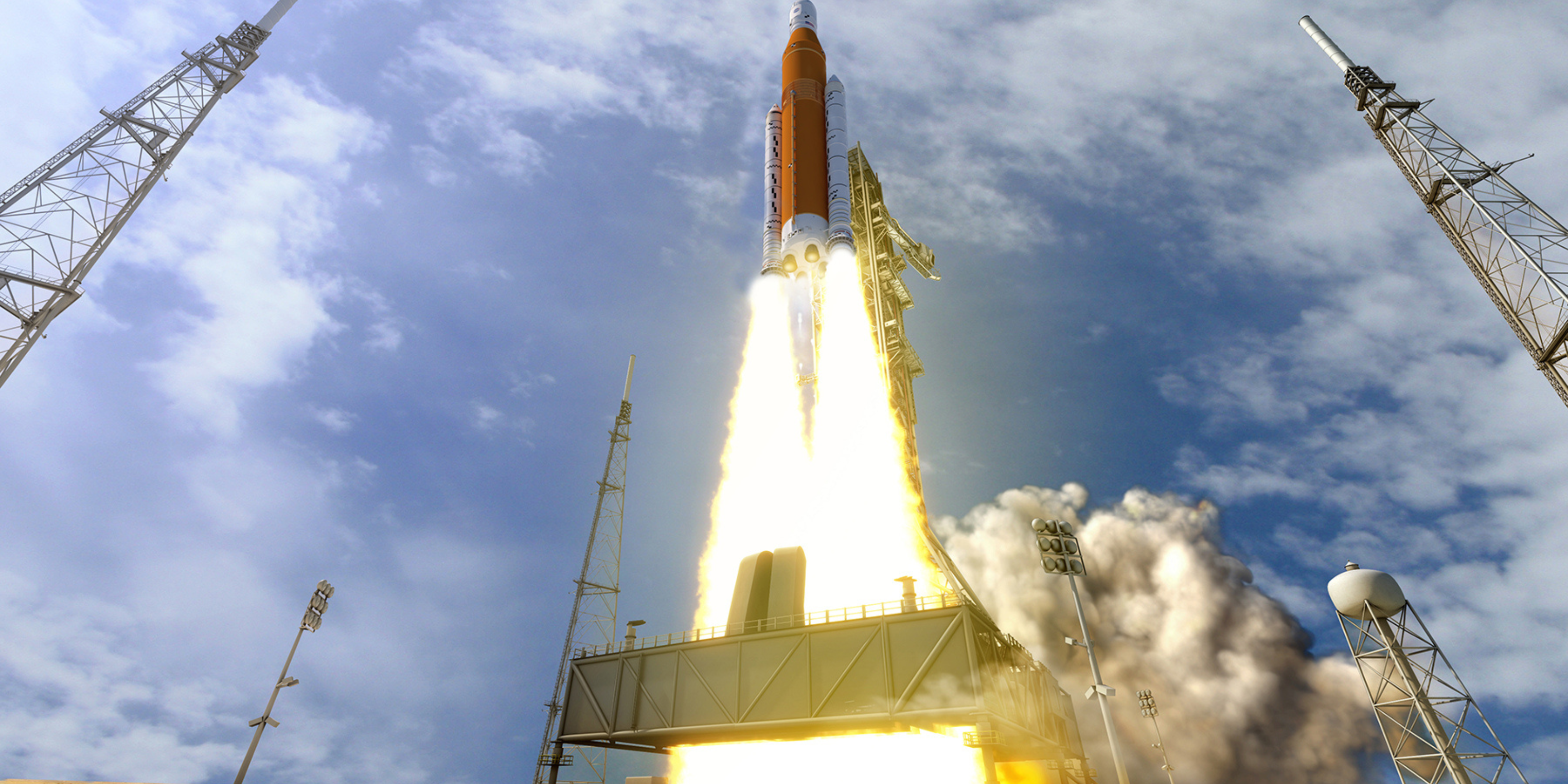 Photo of a rocket launching into space with a large trail of fire and smoke below it.