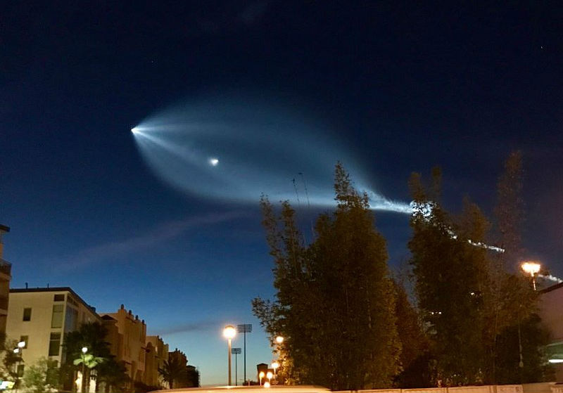 Rocket trails move sideways through the sky