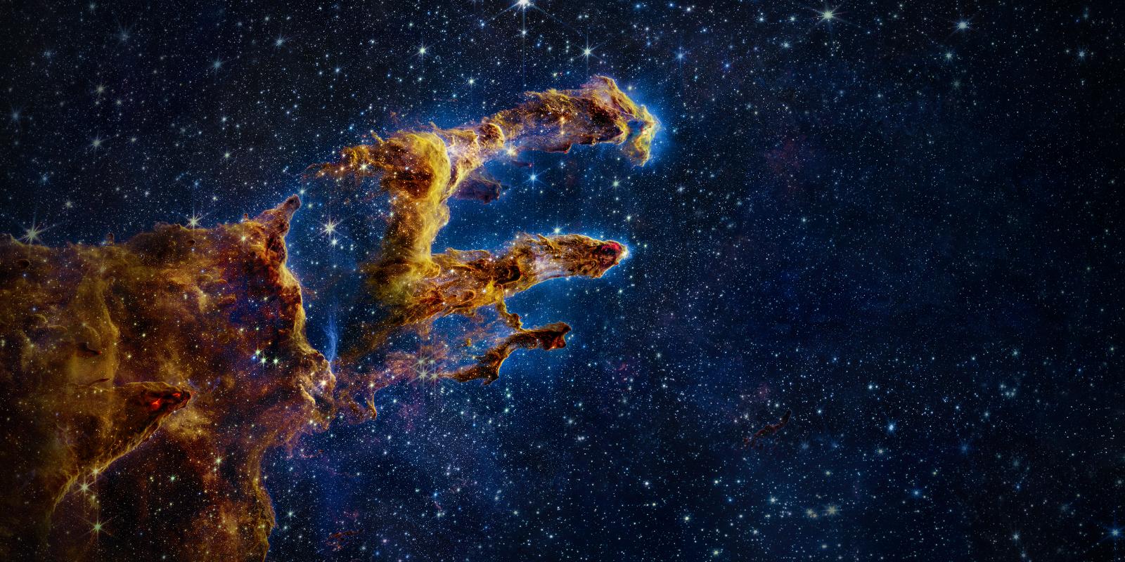 The pillars of creation hang over deep blue black open space