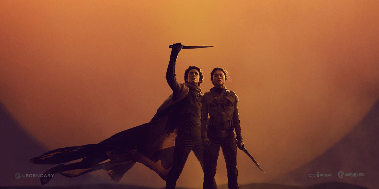 Promo image from Dune Part Two with the main characters standing in front of a sun