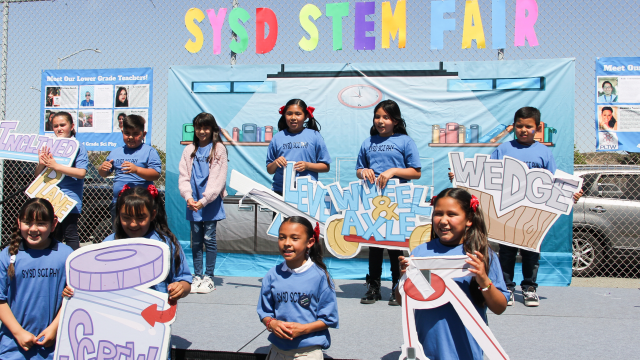 Children participating in an outdoor educational activity on a sunny day
