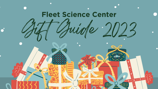 Fleet Science Center Gift Guide 2023 with wrapped present below the text