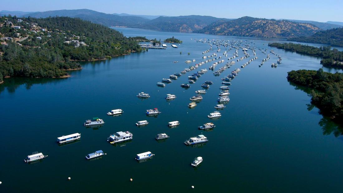 Aerial view of lake with house boats park on it