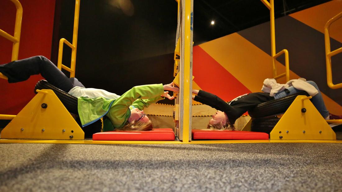 Two people laying upside down.
