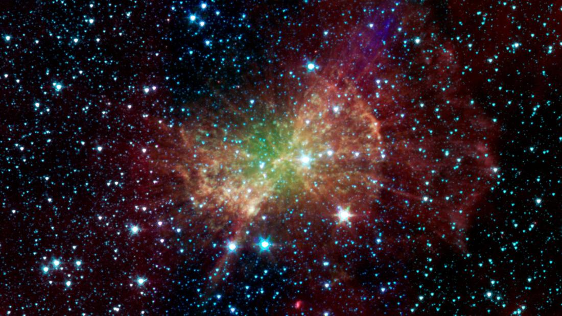 The dumbell nebulae which looks like many stars clustering in the center and fanning out in a bowtie shape of red and purple with a green center