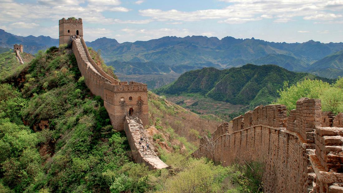 A rural section of the Great Wall of China through lush greenery