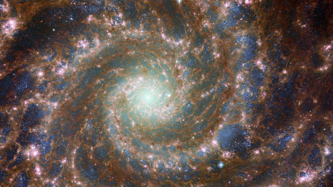 JWST Hubble image of galaxy with swirls and stars