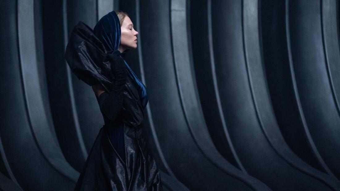 Production still from Dune part two of a woman in all black walking 