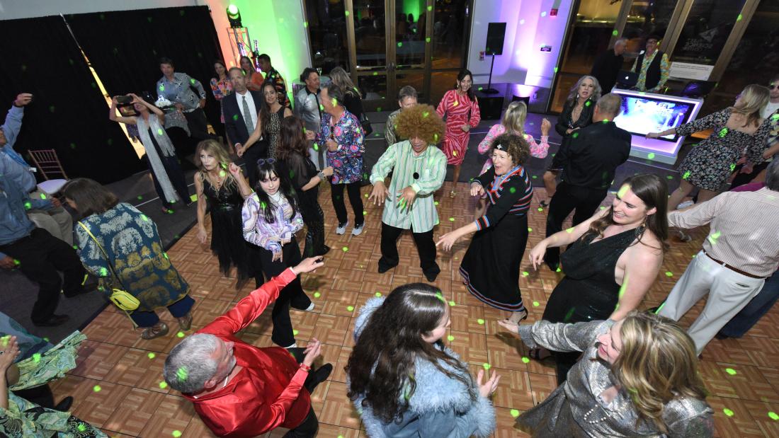 An overheard view of a dance floor with sparkling lights and people dancing