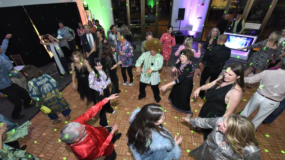 An overheard view of a dance floor with sparkling lights and people dancing