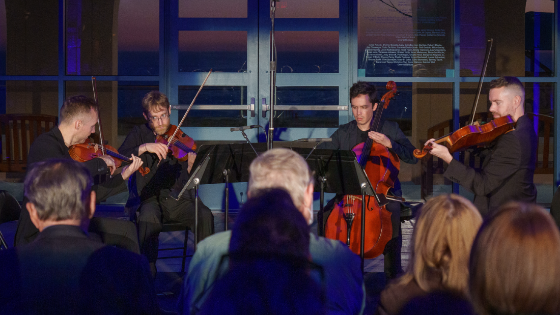 Musicians playing instruments indoors.