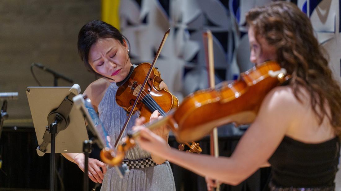 Musicians playing instruments indoors.