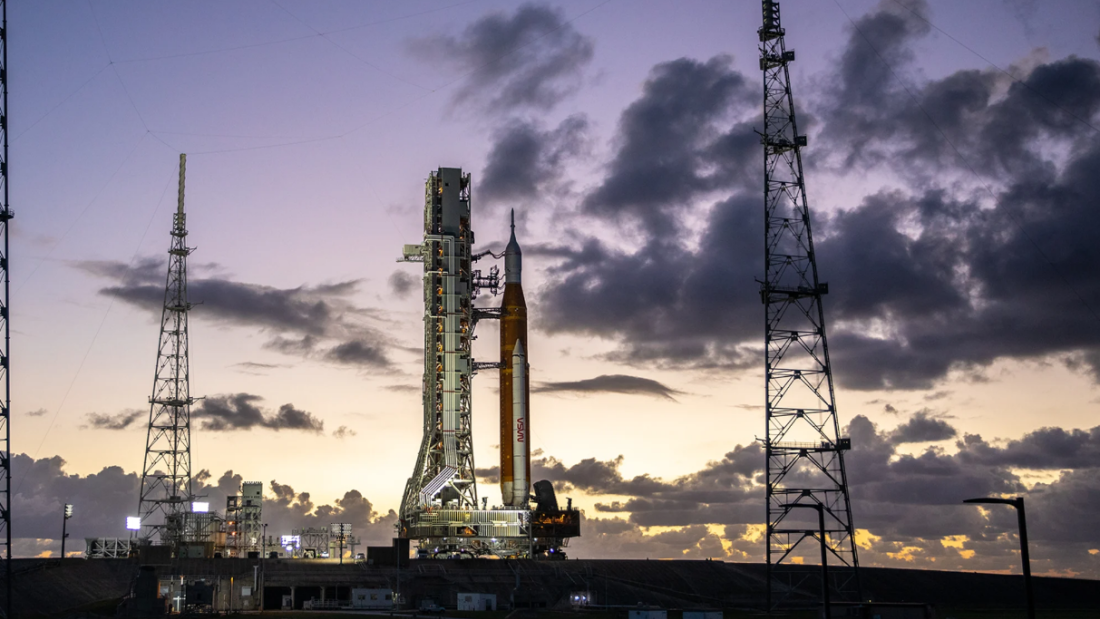 Artemis II rocket on launch pad set against sunrise
