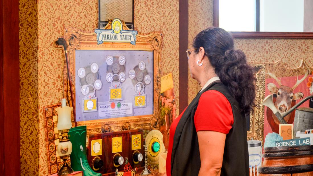 A person facing an exhibit in Mindbender mansion
