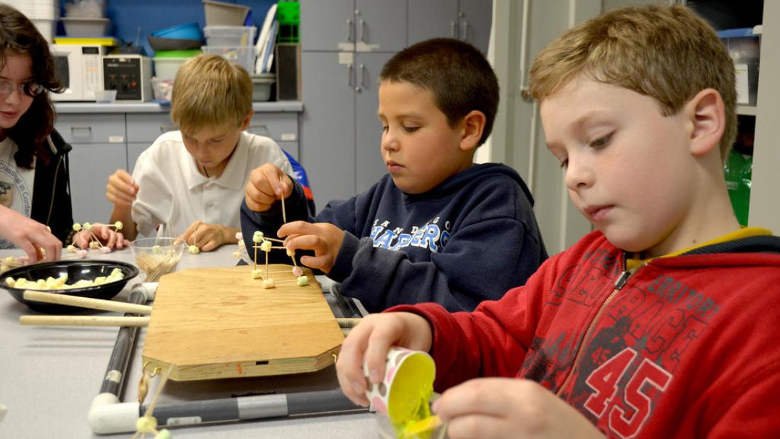 Three elementary school boys working on a project at the Fleet Science Center