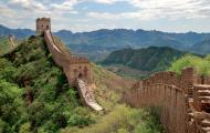 A rural section of the Great Wall of China through lush greenery