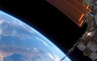 The bottom left is the blue curve of the earth and in the top right is the International Space Station