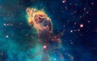 Nebula dust in an aqua and dark blue space image from Hubble 