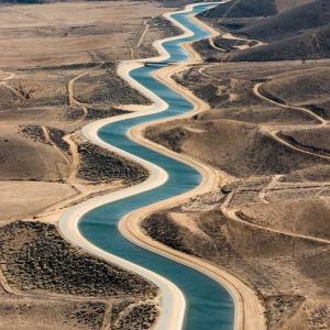 Aerial photo of a manmade river cut through the desert