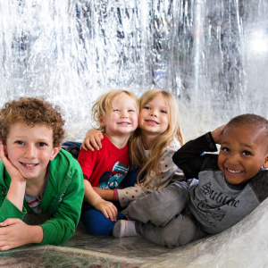 4 children pose inside of the taping shape exhibition 