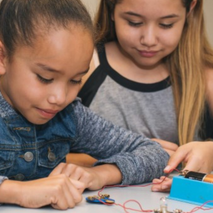 Two girls experimenting with circuits