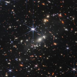 Webb’s image covers a patch of sky approximately the size of a grain of sand held at arm’s length by someone on the ground – and reveals thousands of galaxies in a tiny sliver of vast universeWebb’s image covers a patch of sky approximately the size of a grain of sand held at arm’s length by someone on the ground – and reveals thousands of galaxies in a tiny sliver of vast universe.