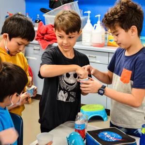 Image of 5 students experimenting with water and sodium  