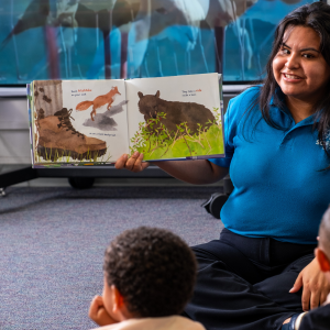 Fleet educator reading to a classroom of young students.