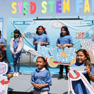 Children participating in an outdoor educational activity on a sunny day