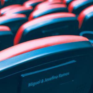 Movie theater seats in multiple rows viewed from behind