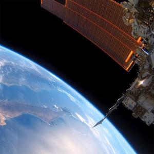 The bottom left is the blue curve of the earth and in the top right is the International Space Station