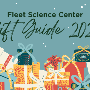 Fleet Science Center Gift Guide 2023 with wrapped present below the text