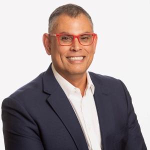image of chance powell in suit wearing red glasses 