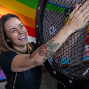 An adult woman engaging with the Velvet Hand exhibit.